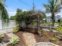 Serene backyard oasis with a wooden pergola covered in vines, creating a tranquil retreat at 2504 W North A St # A, Tampa, FL 33609