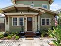 Charming front porch with detailed trim, an American flag, and beautiful landscaping at 2504 W North A St # A, Tampa, FL 33609