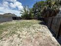 Expansive backyard featuring a tall wooden fence for privacy and seclusion at 2907 W Elrod Ave, Tampa, FL 33611