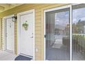 Welcoming entryway features a decorative wreath on the front door and a screened sliding door, bringing the outdoors in at 302 Lake Parsons Grn # 104, Brandon, FL 33511