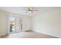 Bright, airy living room with light-colored floors and sliding door access to a private patio, perfect for relaxation at 302 Lake Parsons Grn # 104, Brandon, FL 33511