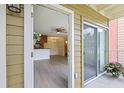 Inviting open-concept living area with modern floors, seamlessly connecting to the kitchen and outdoor patio at 302 Lake Parsons Grn # 104, Brandon, FL 33511