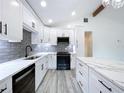 A bright kitchen featuring white cabinets, stainless steel appliances, and a large center island at 309 Congress St, Oldsmar, FL 34677