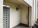 Condo front door with a decorative light fixture and brick walkway at 3151 Landmark Dr # 115, Clearwater, FL 33761