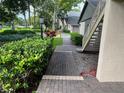Charming condo exterior featuring well-maintained landscaping and a brick pathway at 3151 Landmark Dr # 115, Clearwater, FL 33761