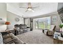A cozy living room offers comfortable seating, plush carpet, and a large bay window at 34215 Kiefer Rd, Dade City, FL 33525