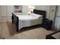Cozy bedroom with sleek black bed frame, matching nightstand, and ample built-in closet space at 4300 E Bay Dr # 309, Clearwater, FL 33764