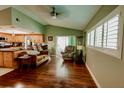 Bright living room with wood floors, vaulted ceiling, and sliding glass doors to the outside at 4434 Dewey Dr, New Port Richey, FL 34652