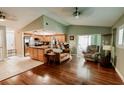 Open-concept living room featuring wood floors, modern lighting, and seamless kitchen access at 4434 Dewey Dr, New Port Richey, FL 34652