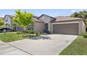 Beautiful single-Gathering home with a two-car garage and a well-manicured lawn showcasing lovely landscaping at 4726 Wild Senna Blvd, Tampa, FL 33619