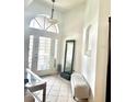 Bright foyer with tile flooring, arched windows, and elegant decor, offering a welcoming entrance at 4745 Trout River Xing, Ellenton, FL 34222