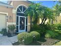 Inviting home entrance with lush landscaping, a custom front door, and ample curb appeal at 4745 Trout River Xing, Ellenton, FL 34222