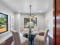 Bright dining room featuring a glass-top table, seating for four, and a decorative chandelier at 5518 21St S Ave, Gulfport, FL 33707