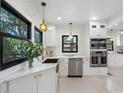 Modern kitchen featuring stainless steel appliances, white cabinets, and a window above the sink at 5518 21St S Ave, Gulfport, FL 33707