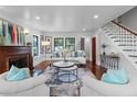 Spacious living room featuring a fireplace, hardwood floors, staircase, and comfortable seating at 5518 21St S Ave, Gulfport, FL 33707
