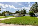 Beautiful single-story home boasting a large, well-maintained lawn and a welcoming driveway at 5519 Kelly N Dr, St Petersburg, FL 33703