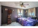Cozy bedroom with a ceiling fan, curtains and unique decor at 5651 6Th St, Zephyrhills, FL 33542