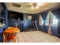 Room with large windows, a treadmill, ceiling fan and table and chairs at 5651 6Th St, Zephyrhills, FL 33542