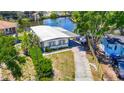 Charming single-story home with a long driveway, boat on the side, and well-maintained lawn at 5806 Portsmouth Dr, Tampa, FL 33615