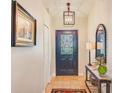 View of the front door and entryway with decorative lighting at 6250 Fairskies Dr, New Port Richey, FL 34655