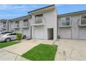 Exterior view features townhome with attached garage, balcony, and green space on the driveway at 6263 93Rd N Ter # 4202, Pinellas Park, FL 33782