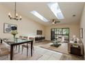 Bright and airy living room with skylights, ceiling fan, modern furniture, and glass sliding doors to patio at 6263 93Rd N Ter # 4202, Pinellas Park, FL 33782