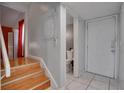 Entryway features wood stairs, a tile floor, and a partial view of a toilet at 6338 Newtown Cir # 38A6, Tampa, FL 33615