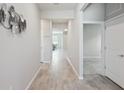 Bright hallway features elegant flooring and neutral paint at 6447 Bradford Woods Dr, Zephyrhills, FL 33542