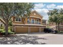 Two-story home featuring a balcony, a three-car garage, and a stone-accented facade at 7001 Interbay Blvd # 203, Tampa, FL 33616