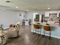 Open-concept living space with kitchen island, stainless steel appliances, and stylish dining area at 7301 Mitchell Ranch Rd, New Port Richey, FL 34655