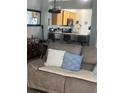 Open living space with wood look floors connecting the living room and kitchen bar seating at 7719 Carriage Pointe Dr, Gibsonton, FL 33534