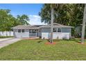 Well-maintained home featuring fresh landscaping, a cozy porch, and ample natural light at 8897 54Th N St, Pinellas Park, FL 33782