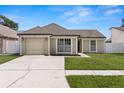 Well-kept single-story home boasting a clean driveway, attached garage, and lush front yard at 9105 Camino Villa Blvd, Tampa, FL 33635