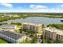 An aerial view shows the proximity of the homes to the lake and the surrounding tropical landscaping at 10002 Key Haven Rd # 503, Seminole, FL 33777