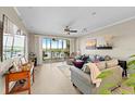 Open living room featuring water views, comfortable seating, and access to the screened lanai at 10002 Key Haven Rd # 503, Seminole, FL 33777