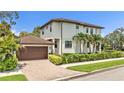 Charming home with a paver driveway leading to a two-car garage and meticulously manicured greenery at 101 Bandera Ne Way, St Petersburg, FL 33704