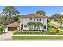Beautiful two-story home featuring a tile roof, lush landscaping, and an attached garage at 101 Bandera Ne Way, St Petersburg, FL 33704