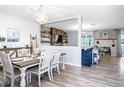 Open dining room features stylish decor, wood floors, and seamless flow to living area at 10624 Aldo Moro Dr, Wimauma, FL 33598
