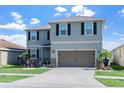 Beautiful two-story home with a two-car garage, well-maintained lawn, and lovely landscaping at 10624 Aldo Moro Dr, Wimauma, FL 33598