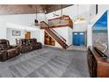Spacious living room with vaulted wood ceilings and a striking staircase design at 11203 Egret Nest Ct, Riverview, FL 33569