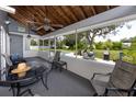 Relaxing screened porch with comfortable seating, ceiling fans, and a backyard view of the swimming pool at 11203 Egret Nest Ct, Riverview, FL 33569