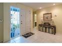 Bright foyer featuring tile floors, a decorative front door and stylish console table at 11501 Cerca Del Rio Pl, Temple Terrace, FL 33617