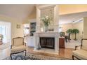 Elegant fireplace with white mantle, flanked by built-in shelves and views of the dining area at 11501 Cerca Del Rio Pl, Temple Terrace, FL 33617