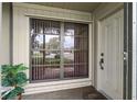 Home's exterior featuring a window with blinds and a decorative front door at 12156 Meadowbrook Ln, Largo, FL 33774