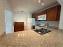 Functional kitchen features granite countertops, ample cabinetry, and white appliances at 12300 Vonn Rd # 9105, Largo, FL 33774
