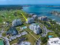 Aerial view of luxury waterfront condo complex with golf course and water views at 125 Belleview Blvd # 503, Belleair, FL 33756