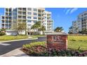 Beautiful condominium building with lush landscaping and a prominent street address sign at 125 Belleview Blvd # 503, Belleair, FL 33756