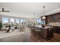Spacious living room with open kitchen, large windows, hardwood floors, and modern furnishings at 125 Belleview Blvd # 503, Belleair, FL 33756