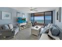 Inviting living room featuring stylish furniture, modern decor, and panoramic views of the ocean from the balcony at 1340 Gulf Blvd # 16F, Clearwater, FL 33767