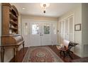 Welcoming foyer with classic rolltop desk, antique bench, and stylish rug at 1370 Hill Dr, Largo, FL 33770